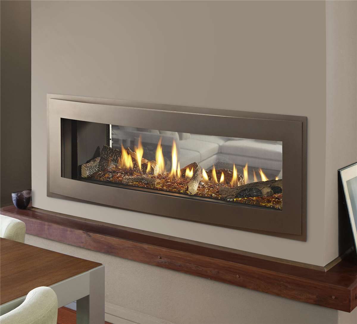 Heatilator Crave 48" see-through gas fireplace with Illusion front and amber glass media.