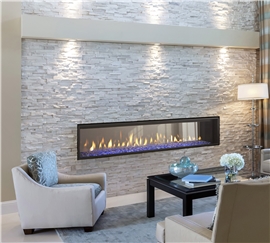 Heatilator Crave 72" see-through gas fireplace with clean face trim and blue glass media.